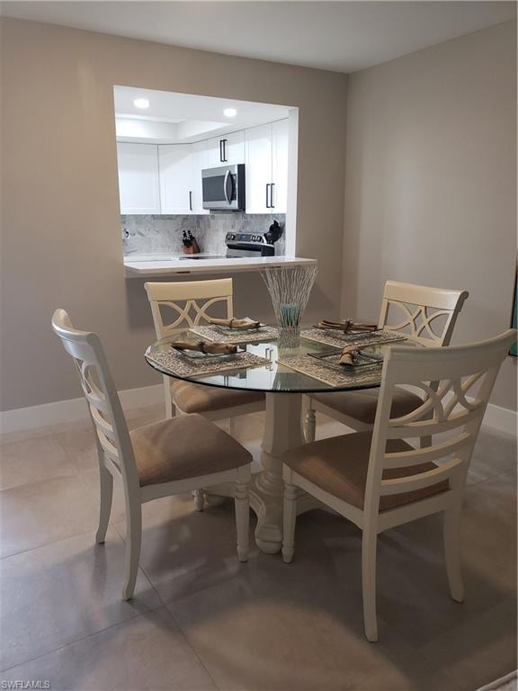 Dining room has pass through window to kitchen with quartz countertop
