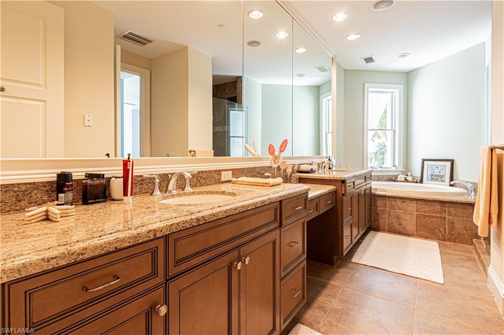 Full bath with a bath, vanity, tile patterned flooring, and visible vents