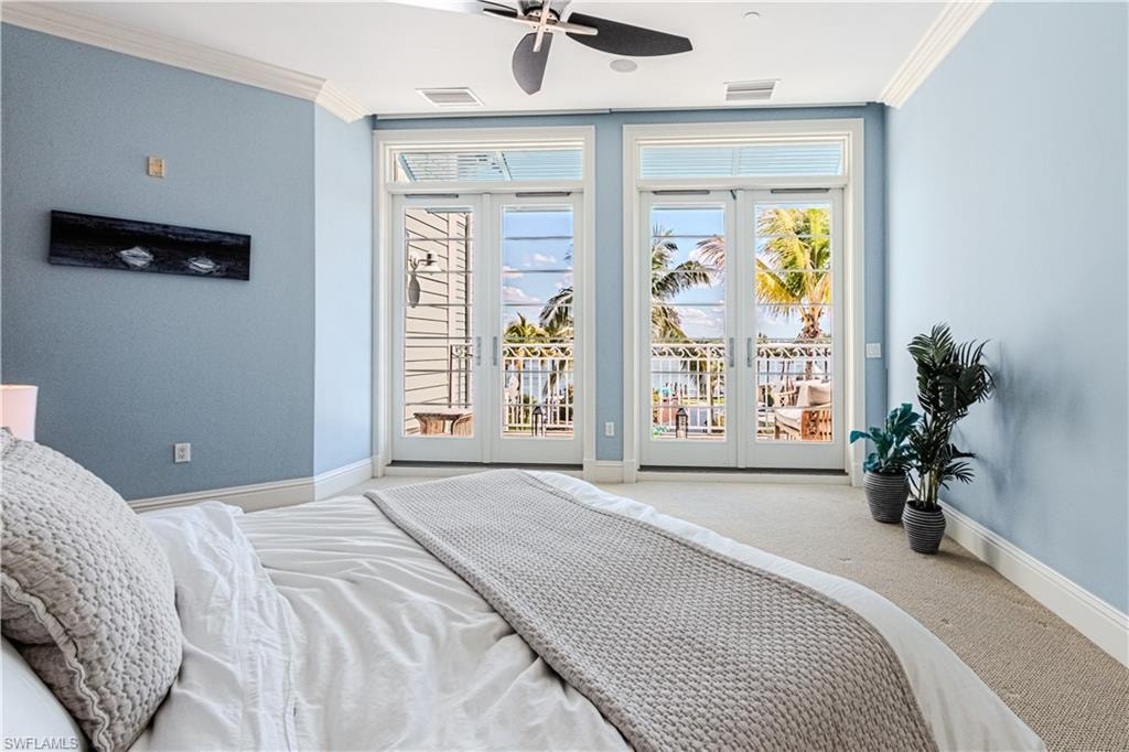 Bedroom featuring crown molding, french doors, visible vents, and access to exterior