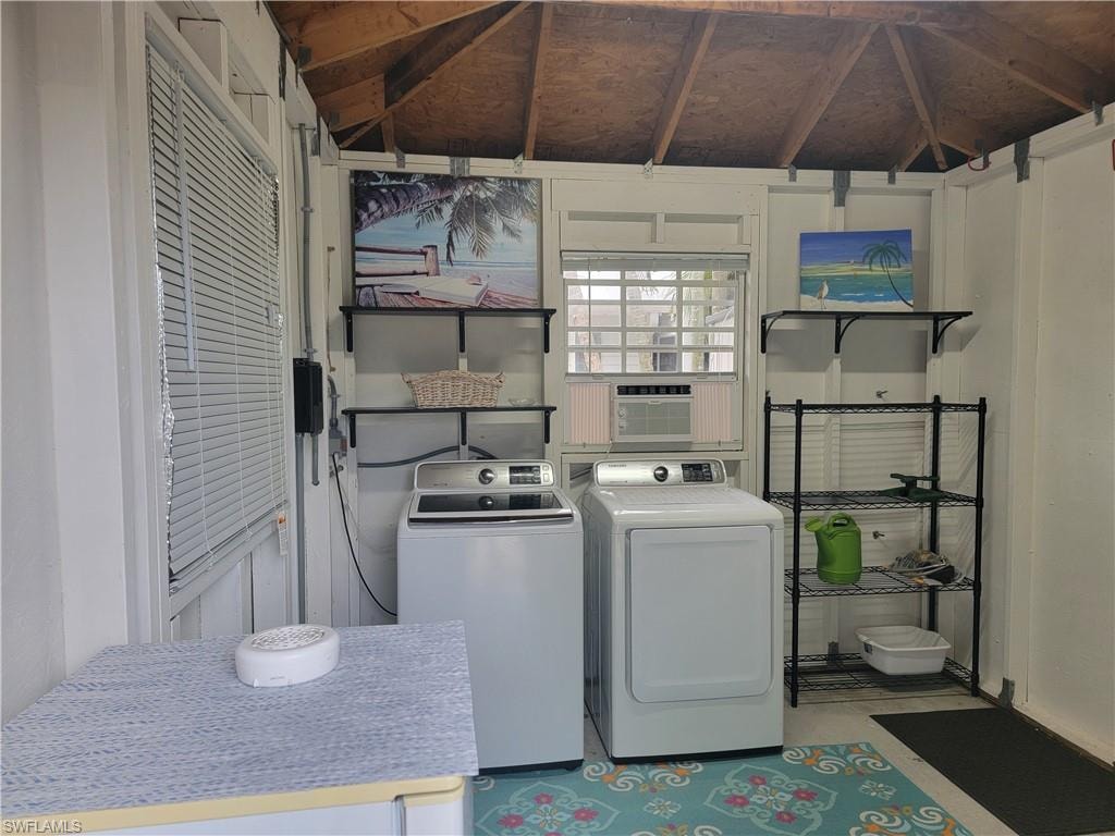 Clothes washing area featuring washing machine and dryer and cooling unit