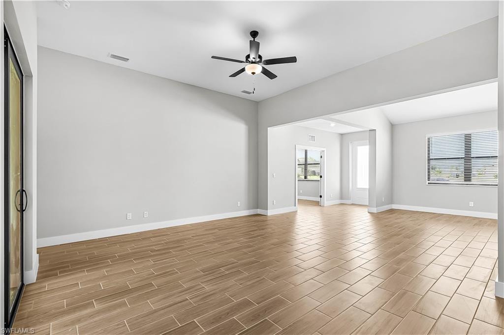 Empty room with wood tiled floors and ceiling fan