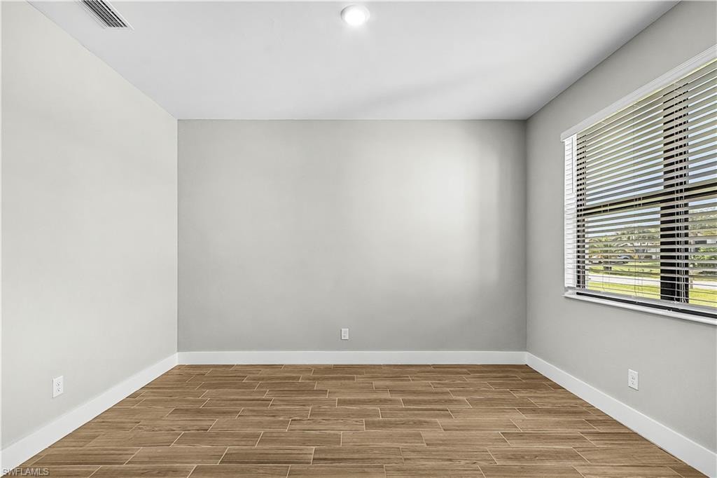 Unfurnished room featuring wood finish floors