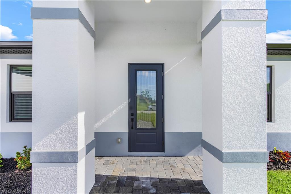 Property entrance featuring stucco siding
