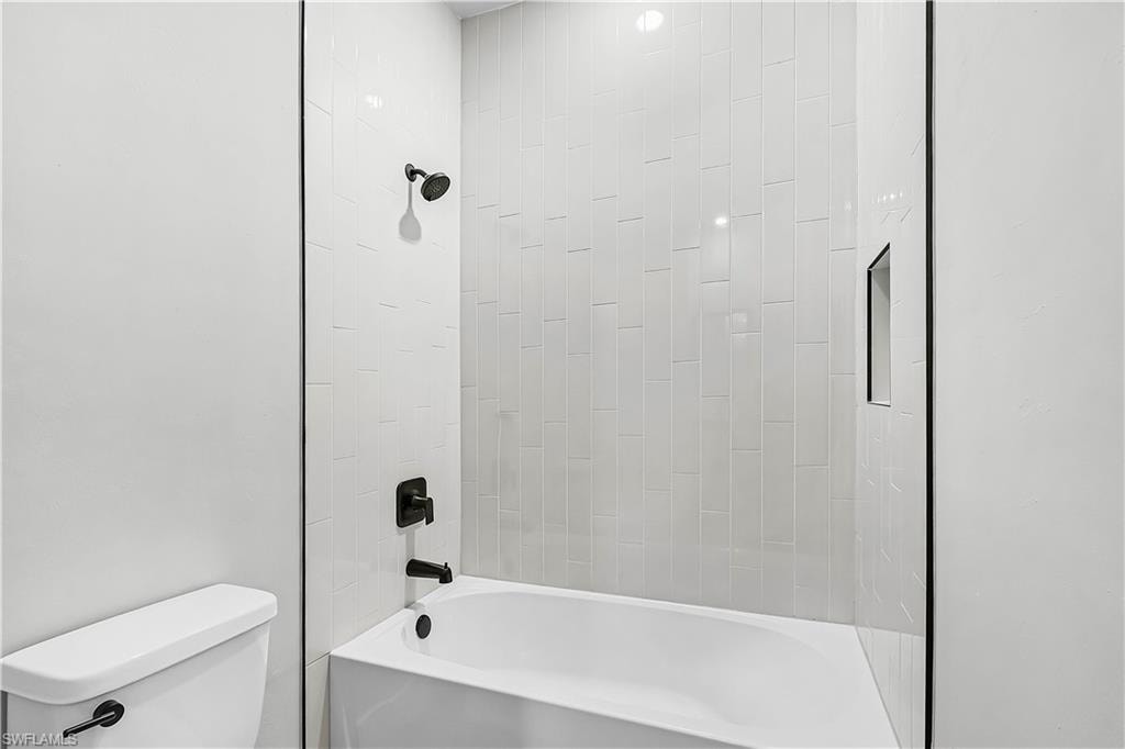 Bathroom featuring  shower combination and toilet