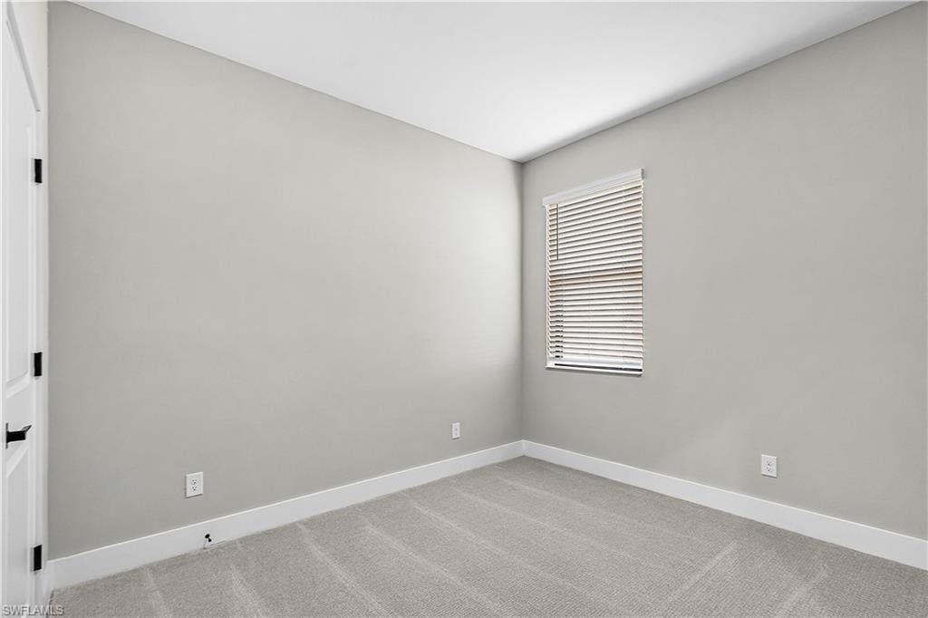 Empty room featuring carpet flooring