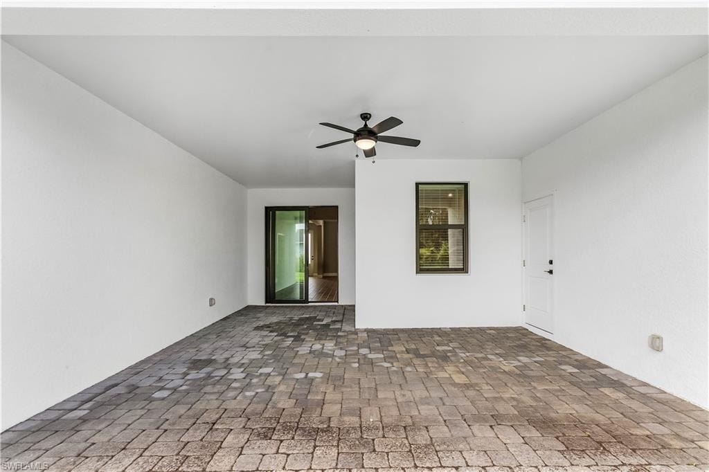 Spare room featuring ceiling fan and brick patterned floors