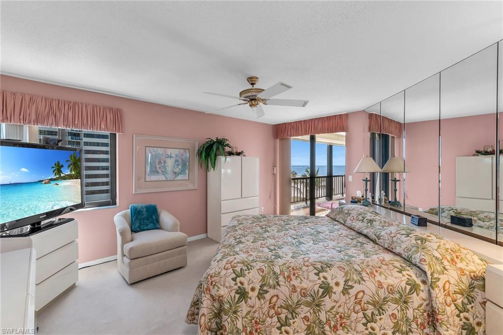 Carpeted bedroom featuring access to exterior, ceiling fan, and baseboards