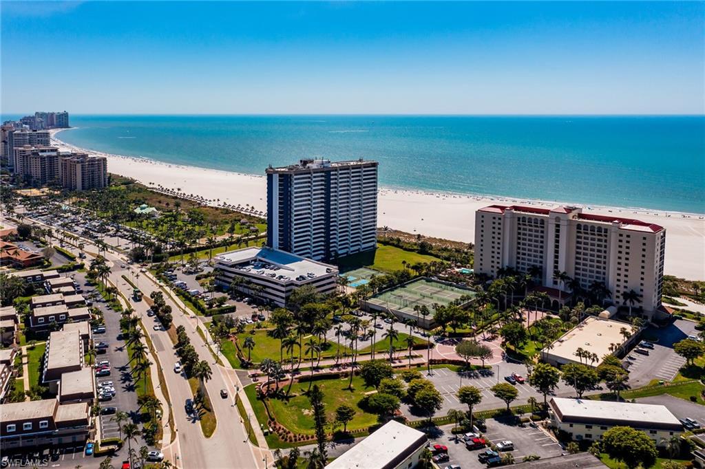 Drone / aerial view featuring a city view, a water view, and a beach view