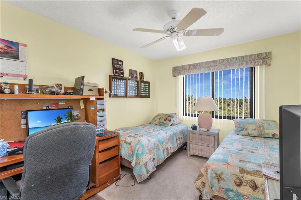 Bedroom featuring ceiling fan and carpet flooring