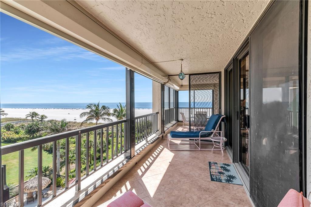 Balcony with a water view and a beach view
