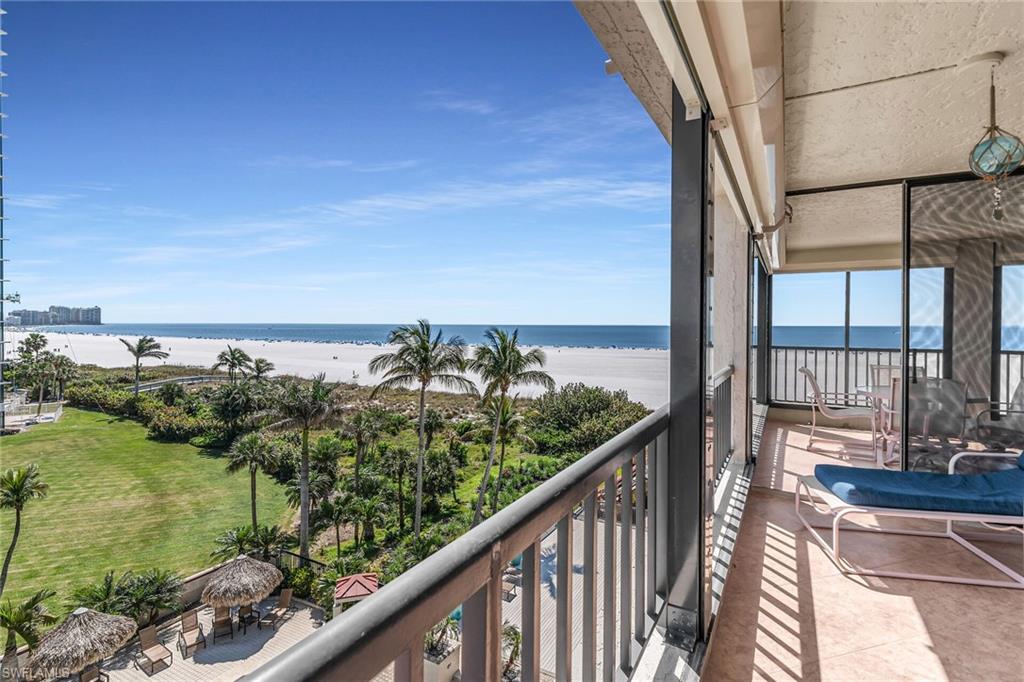 Balcony with a view of the beach and a water view