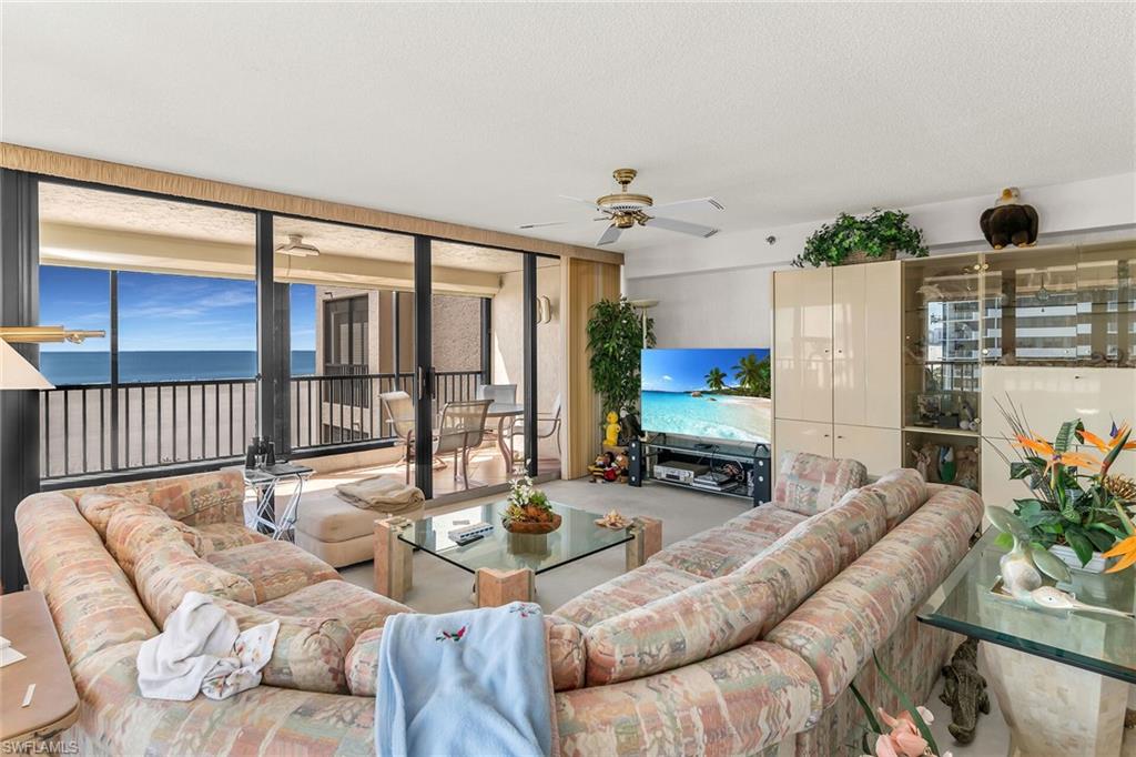 Living room with ceiling fan and a textured ceiling
