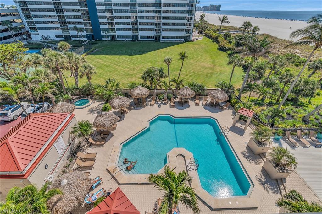 Community pool with a patio area and a water view