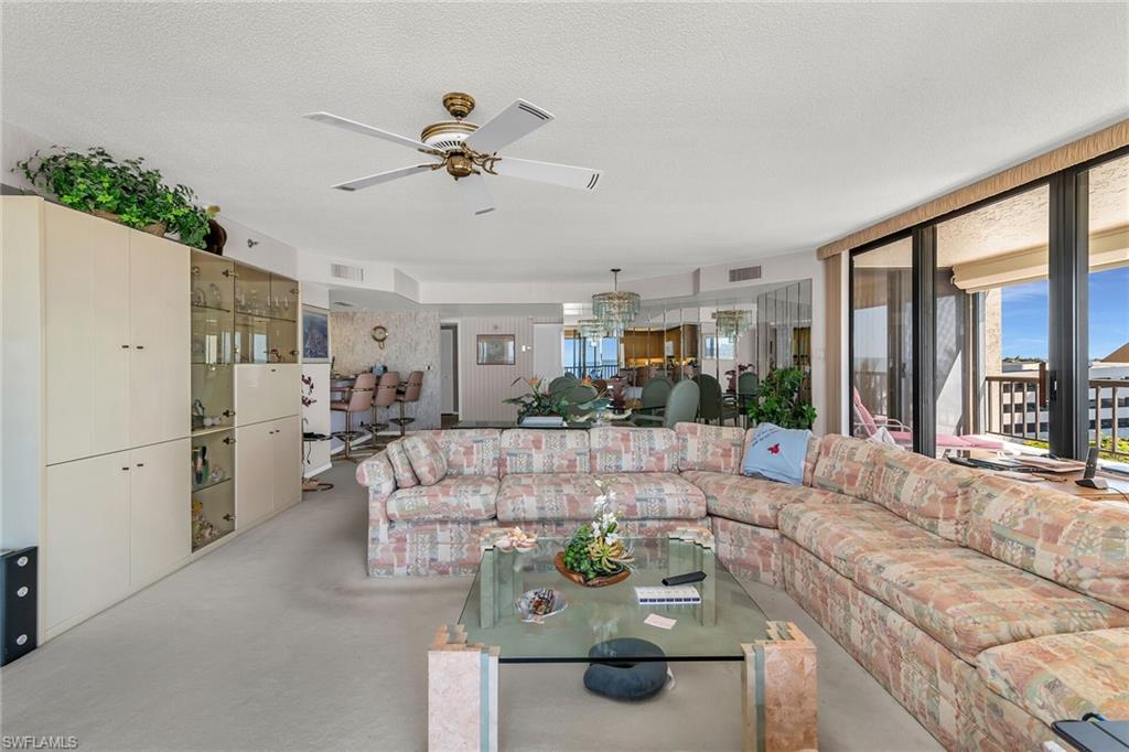 Living area with a textured ceiling, visible vents, and finished concrete floors