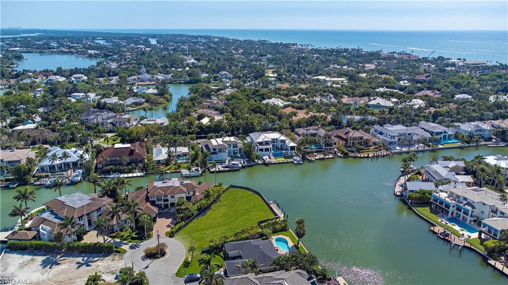 Aerial view of residential area featuring a large body of water