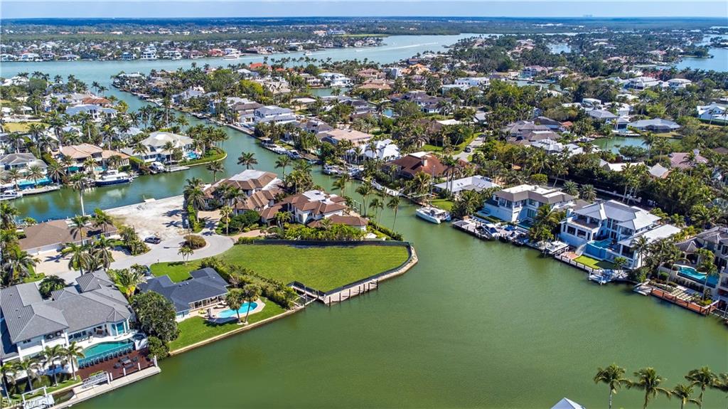Aerial view of residential area featuring a nearby body of water