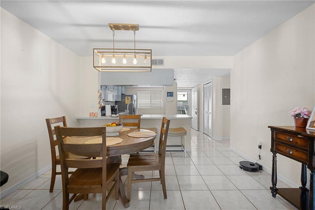 Dining space featuring light tile patterned floors