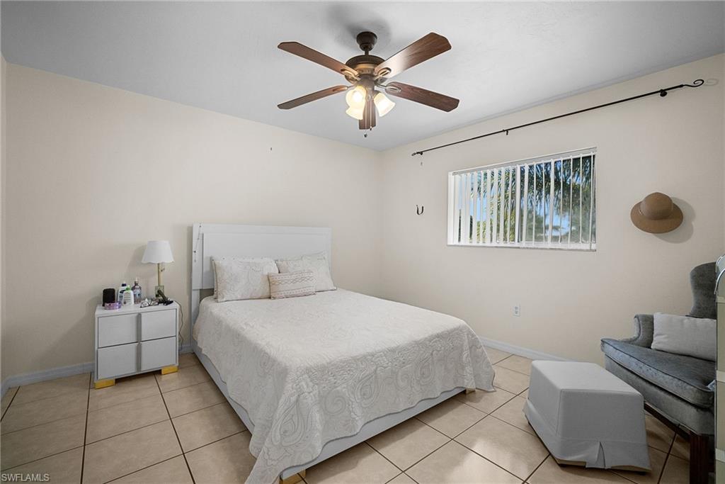 Bedroom featuring light tile patterned floors and ceiling fan