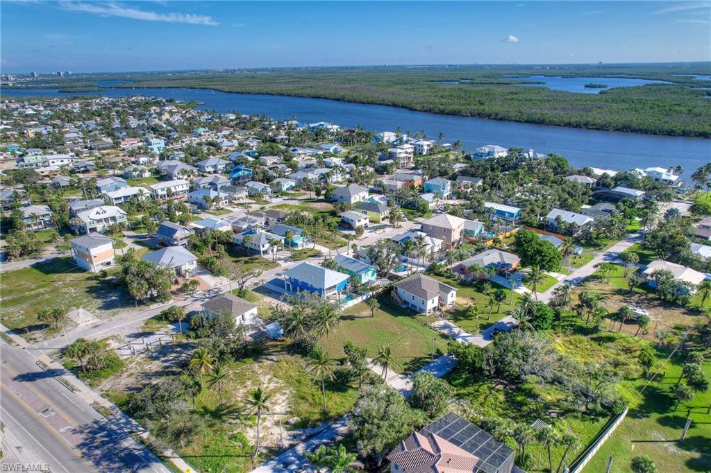 Aerial view of property's location with nearby suburban area and a nearby body of water