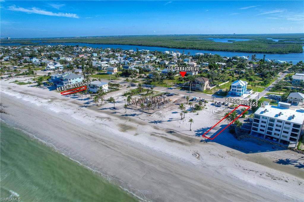 Aerial view of residential area featuring waterfront with a beach
