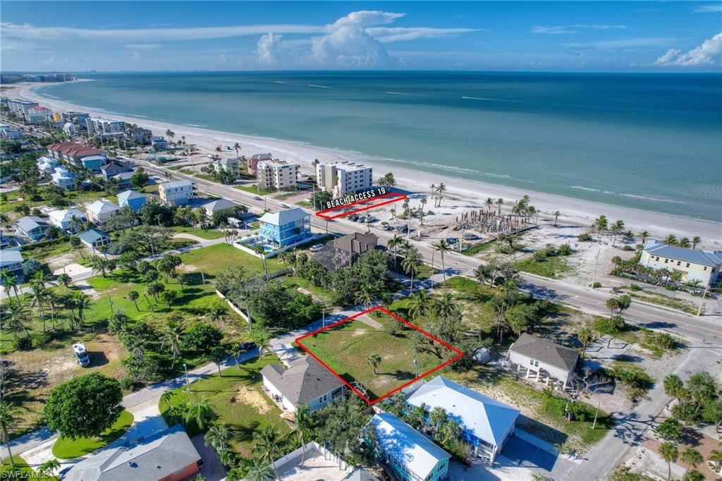 Aerial overview of property's location featuring property parcel outlined and waterfront with a beach