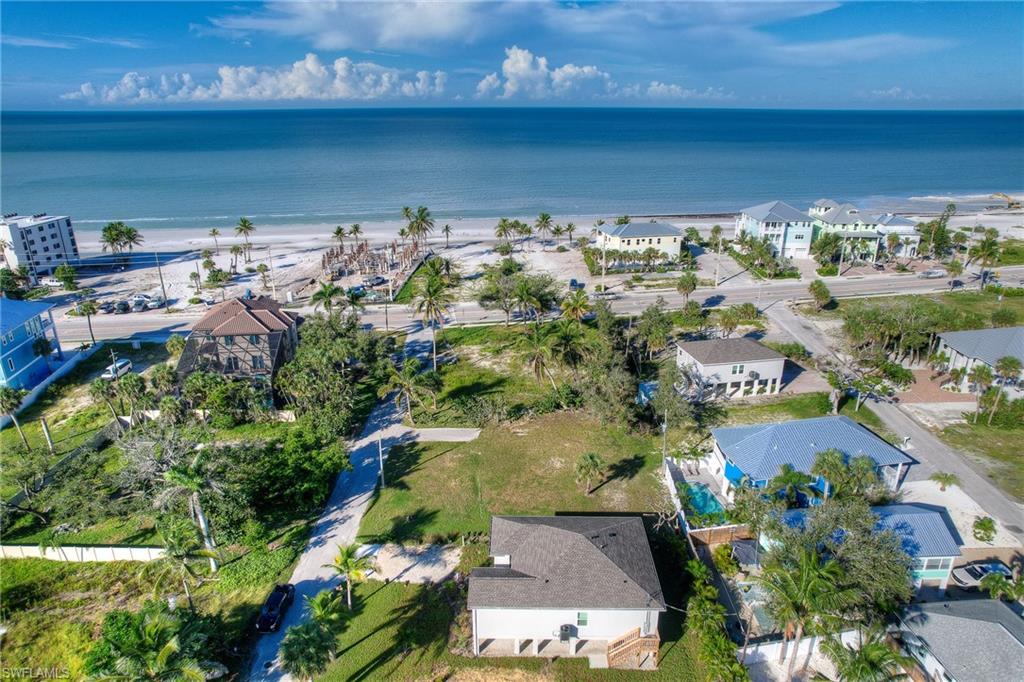 Aerial view of property and surrounding area with expansive coastline and nearby suburban area
