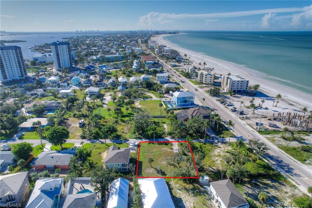 Aerial overview of property's location with waterfront with a beach and property boundaries highlighted