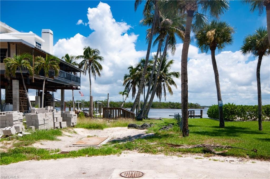 View of yard with a water view and a patio