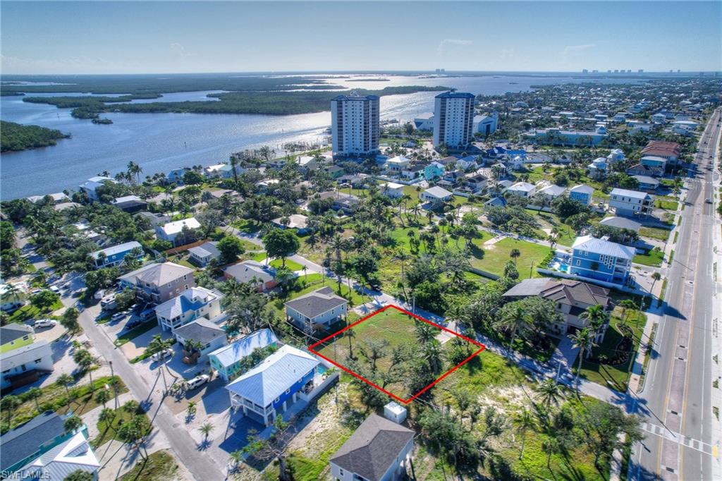 View of urban area with a nearby body of water and property boundaries highlighted