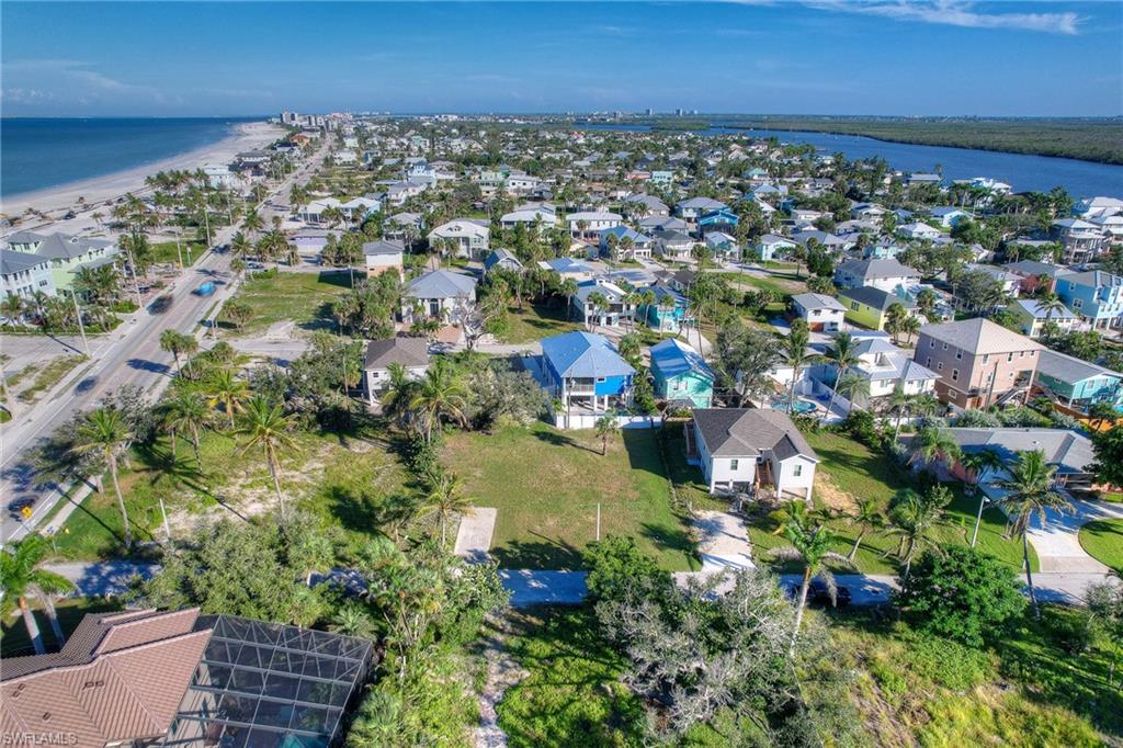 Aerial overview of property's location with expansive coastline and nearby suburban area