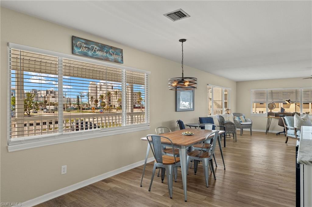Dining area with baseboards, visible vents, and wood finished floors