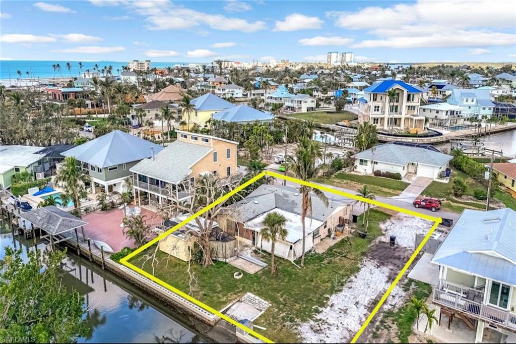 Drone / aerial view with a water view and a residential view