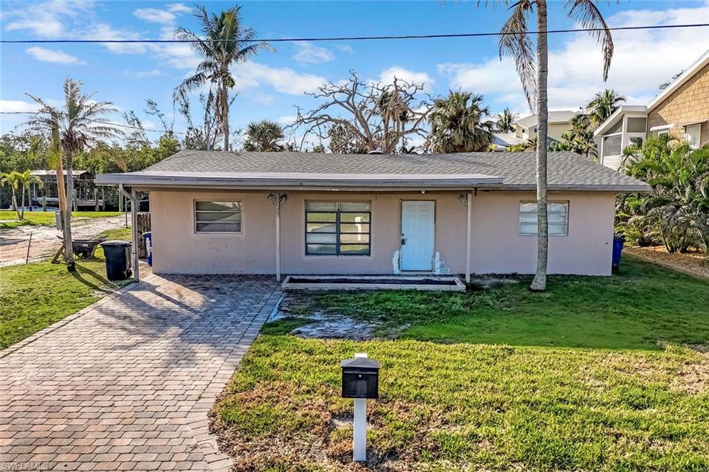Front elevation of home with paved driveway