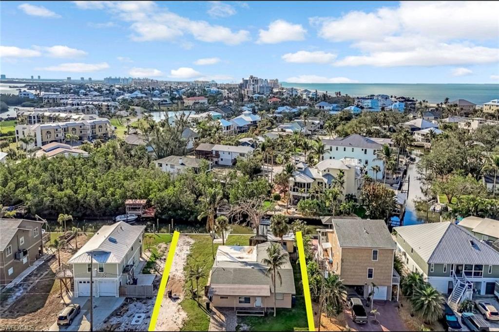 Drone / aerial view with a water view and a residential view