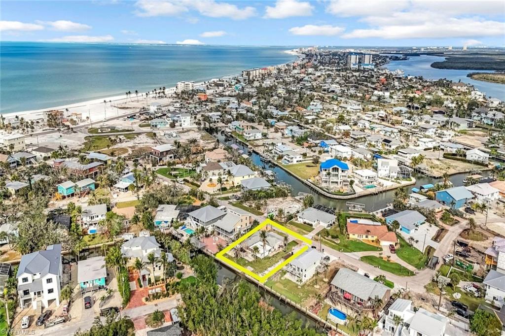 Drone / aerial view with a residential view and a water view