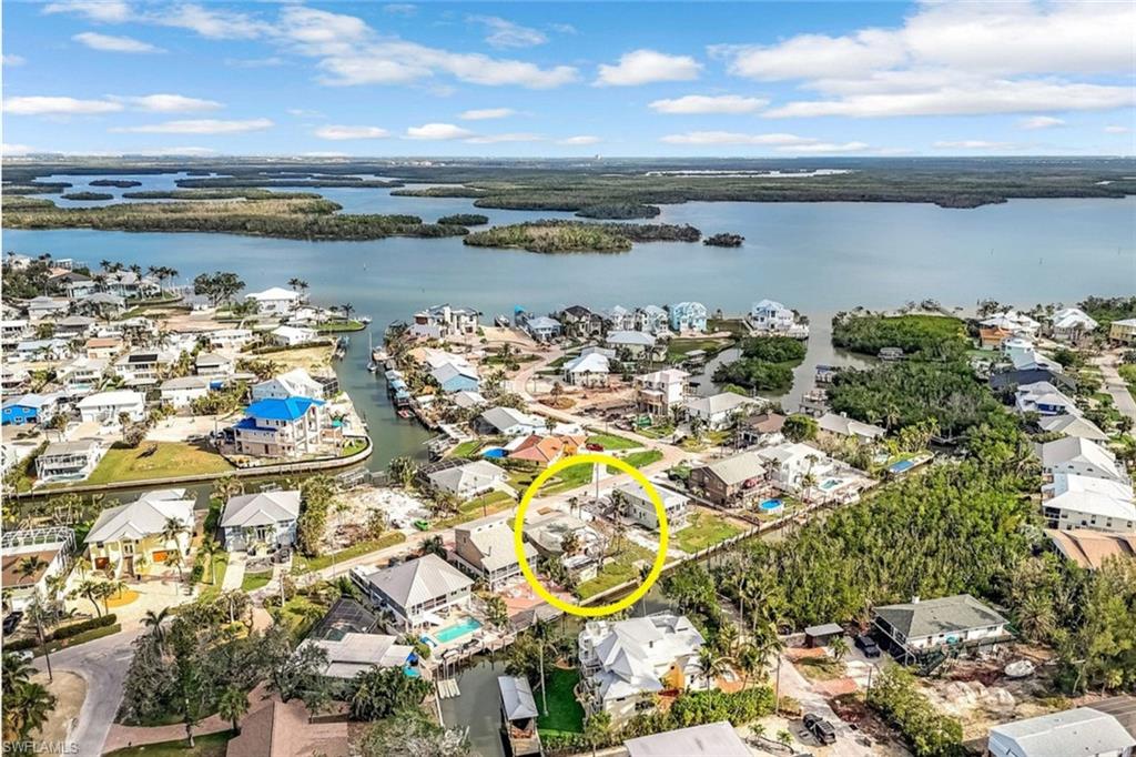Drone / aerial view with a water view and a residential view