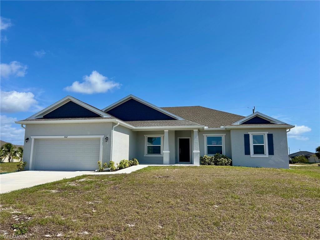Ranch-style house featuring stucco siding, a front yard, concrete driveway, and a garage