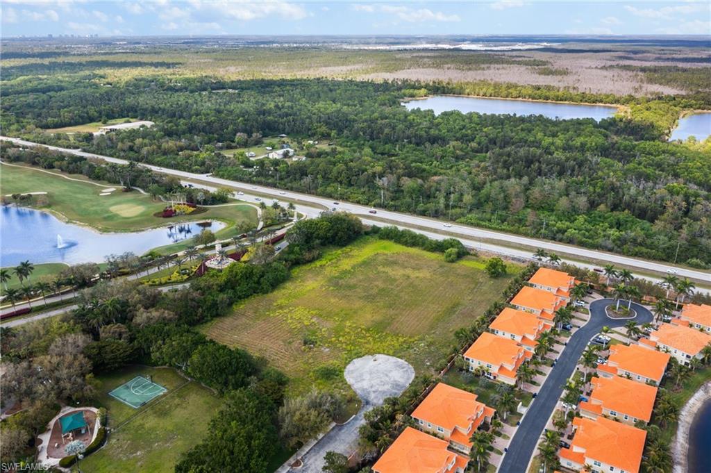 Birds eye view of property featuring a wooded view and a water view
