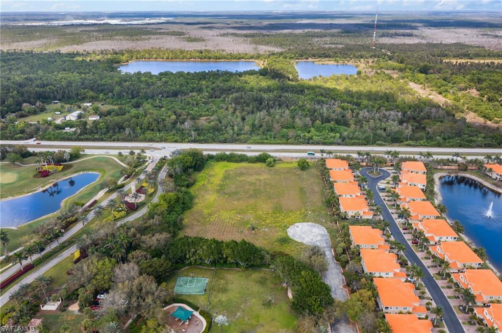 Drone / aerial view with a forest view and a water view