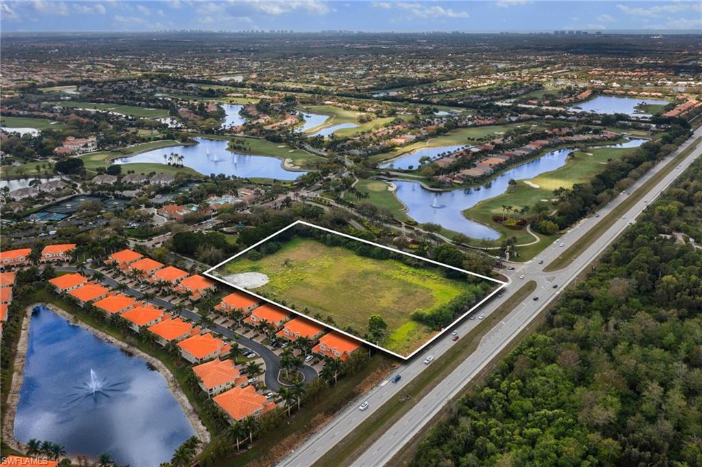 Birds eye view of property with a water view