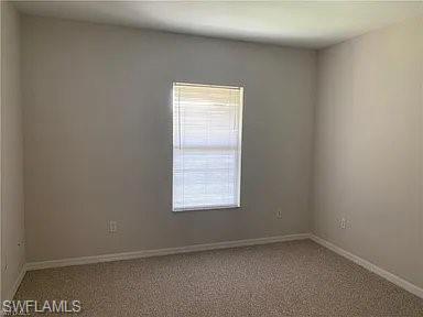 Unfurnished room with carpet and baseboards