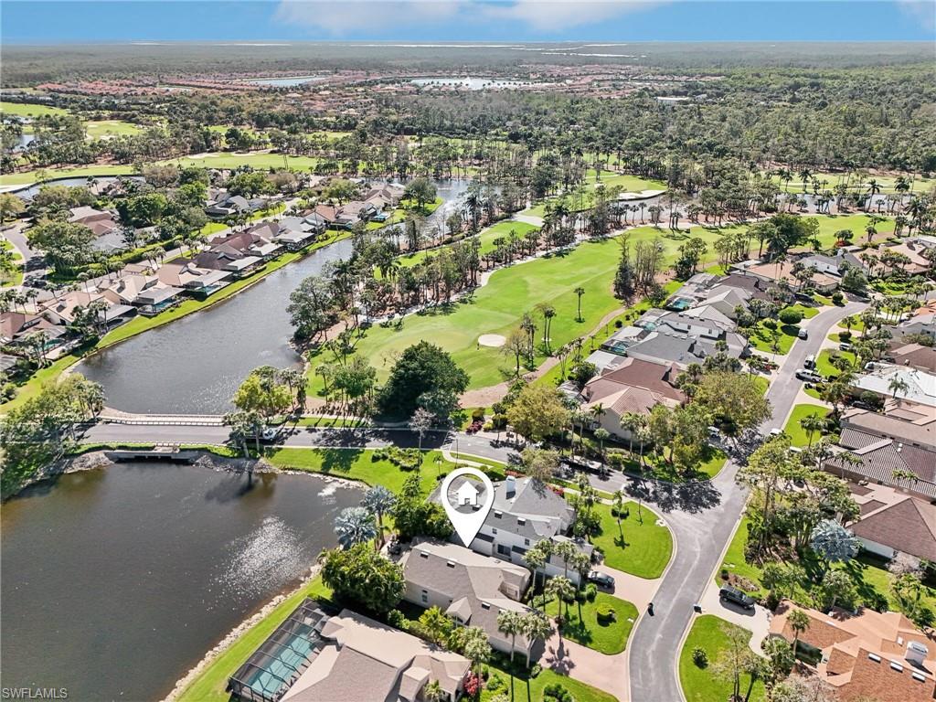 Birds eye view of property with a residential view, view of golf course, and a water view