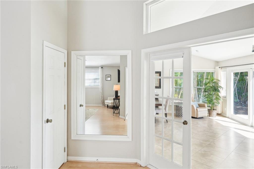 Entryway with a towering ceiling, a wealth of natural light, and baseboards
