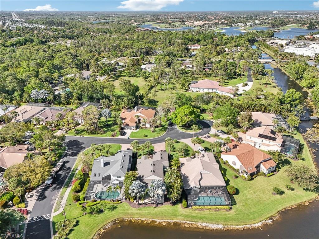 Birds eye view of property featuring a water view and a residential view