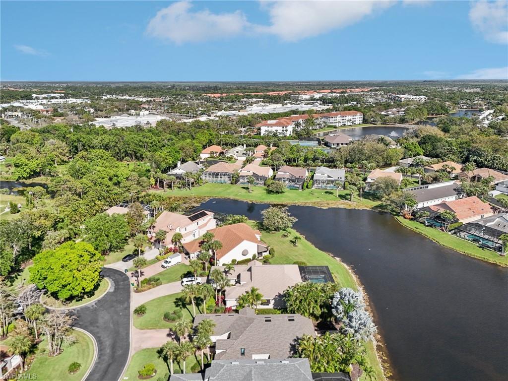 Birds eye view of property featuring a water view and a residential view