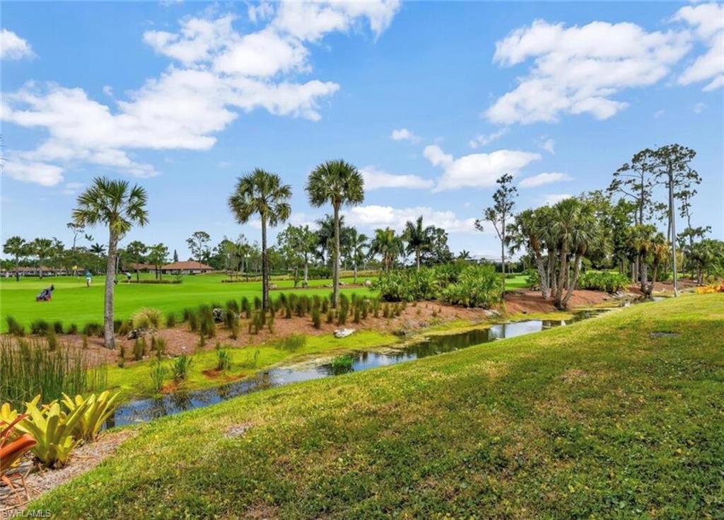 View of condo community featuring a yard and a water view