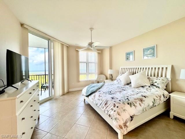 Bedroom featuring light tile patterned floors, baseboards, access to exterior, and a ceiling fan