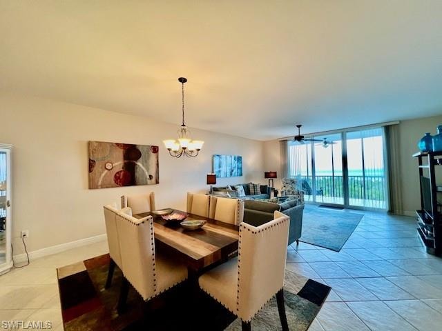Dining space with a chandelier, light tile patterned floors, baseboards, and expansive windows