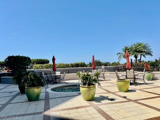 View of home's community with outdoor dining space and a patio