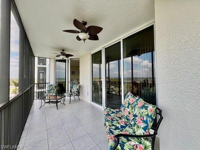 Sunroom featuring a wealth of natural light and a ceiling fan